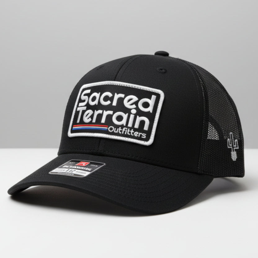 Black cap with branding on a white wall