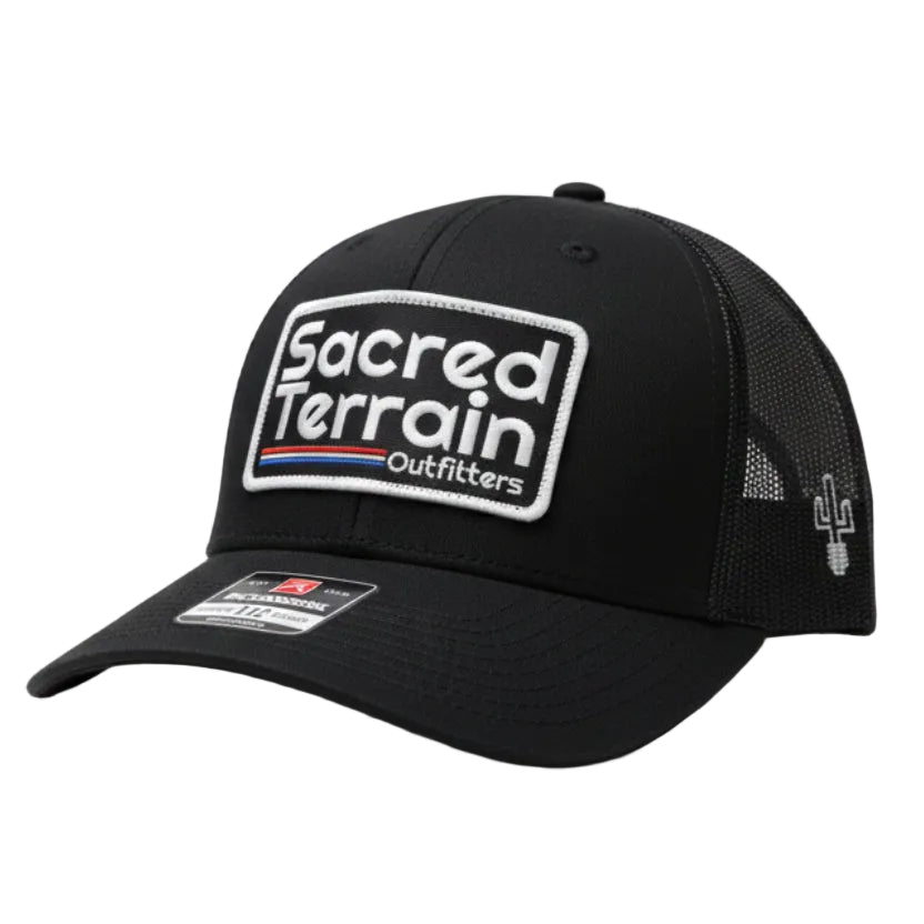 Black cap with branding on a white wall