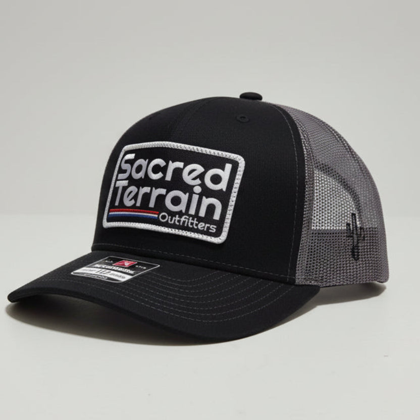 Black cap with a logo on a white surface