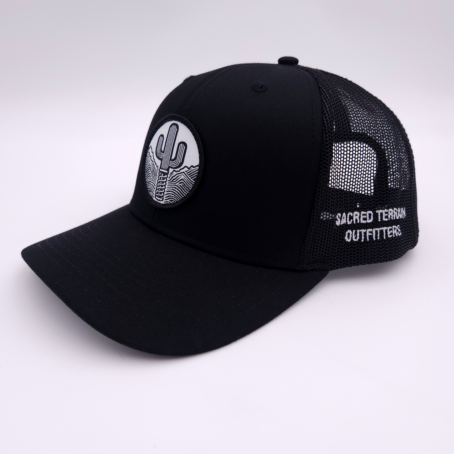 Sacred Stitches 112 Black on Black Trucker Cap - Richardson with Woven Patch