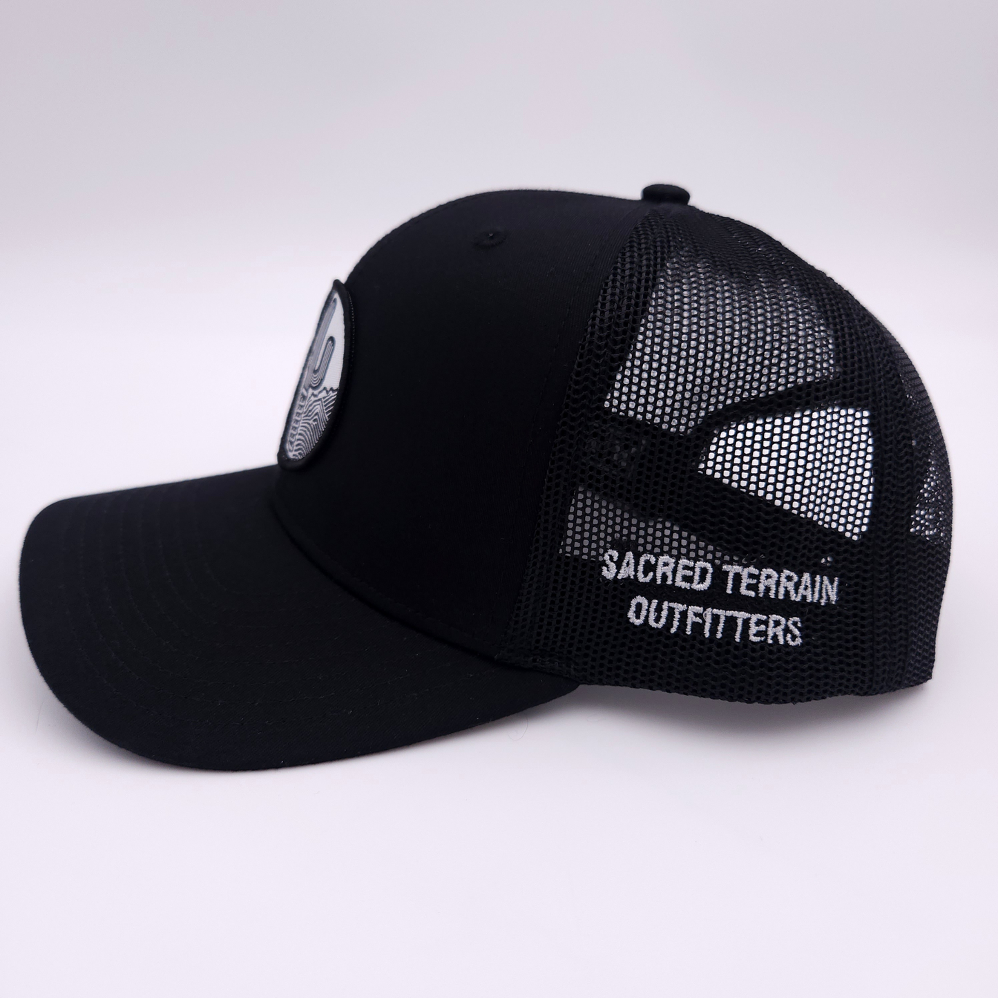 Sacred Stitches 112 Black on Black Trucker Cap - Richardson with Woven Patch