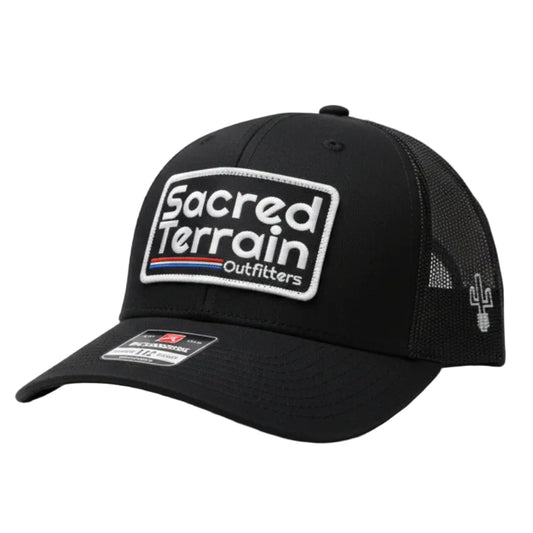 Black cap with branding on a white wall