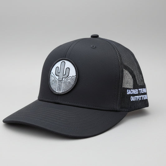 Sacred Stitches 112 Black on Black Trucker Cap - Richardson with Woven Patch
