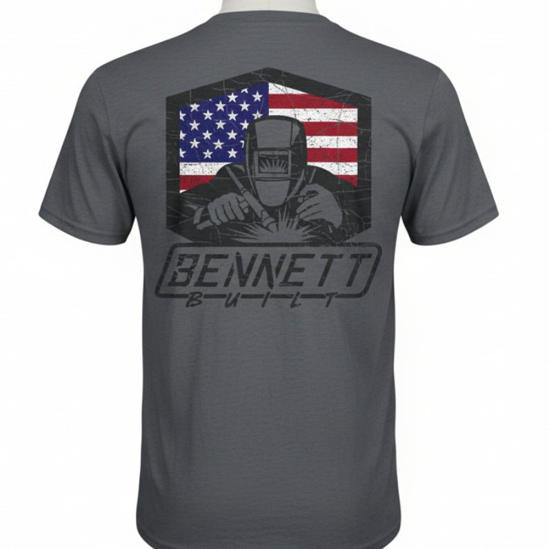 Gray t-shirt with a graphic of a welder and American flag, featuring the brand 'Bennett Built'.