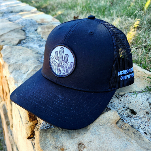 Sacred Stitches 112 Black on Black Trucker Cap - Richardson with Woven Patch